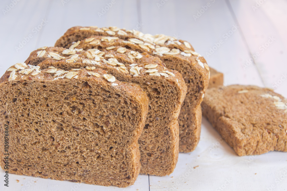 Fresh whole grain bread on white wood background Fresh whole grain bread on white wood background