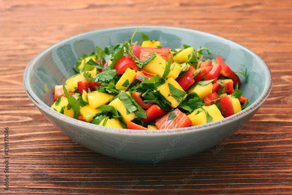 Mango salad with pepper and parsley in a bowl