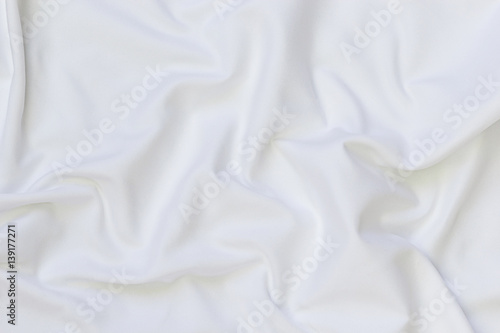 Close up of white bedding sheets and empty space
