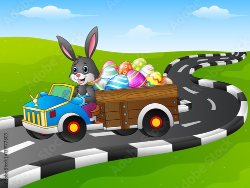 Easter Bunny driving a car carrying easter eggs on road