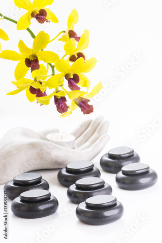 Spa with basalt stones  tea light and orchid flowers close up