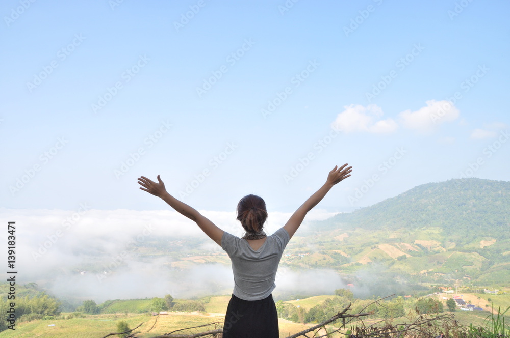 asian woman stand and show hand to sky, subject is blurred asian woman stand and show hand to sky, subject is blurred