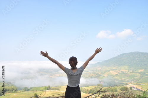 asian woman stand and show hand to sky, subject is blurred