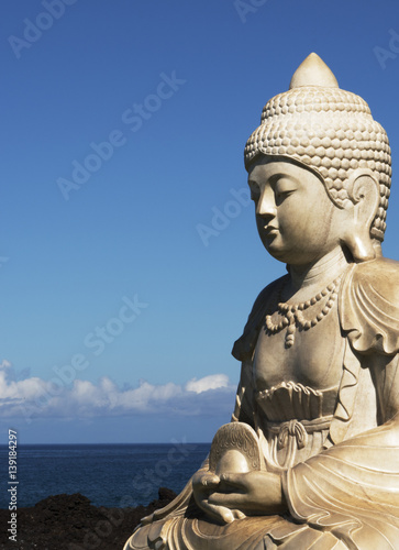 buddha with ocean and blue sky