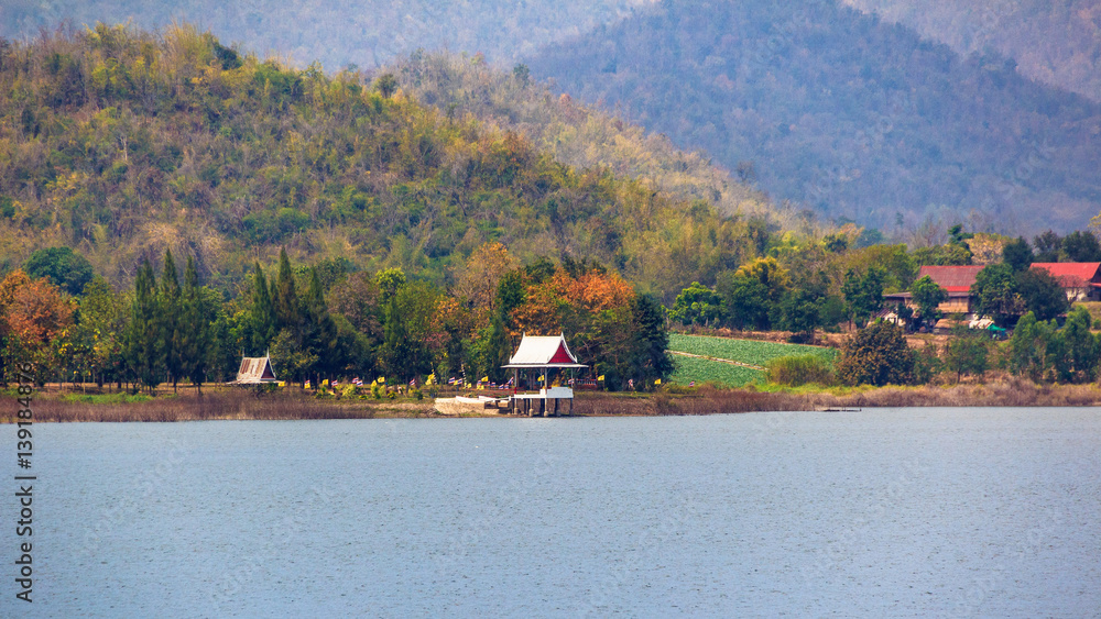 temple with forest conservation beside of reservoir.