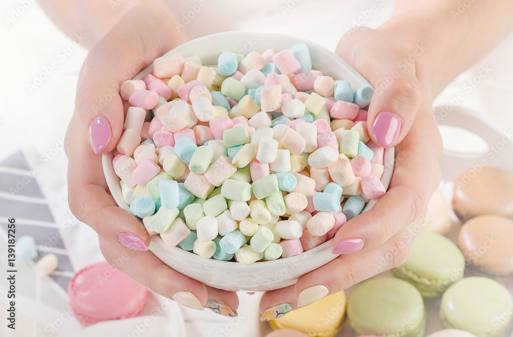 Womans hands with marshmallows Womans hands with marshmallows