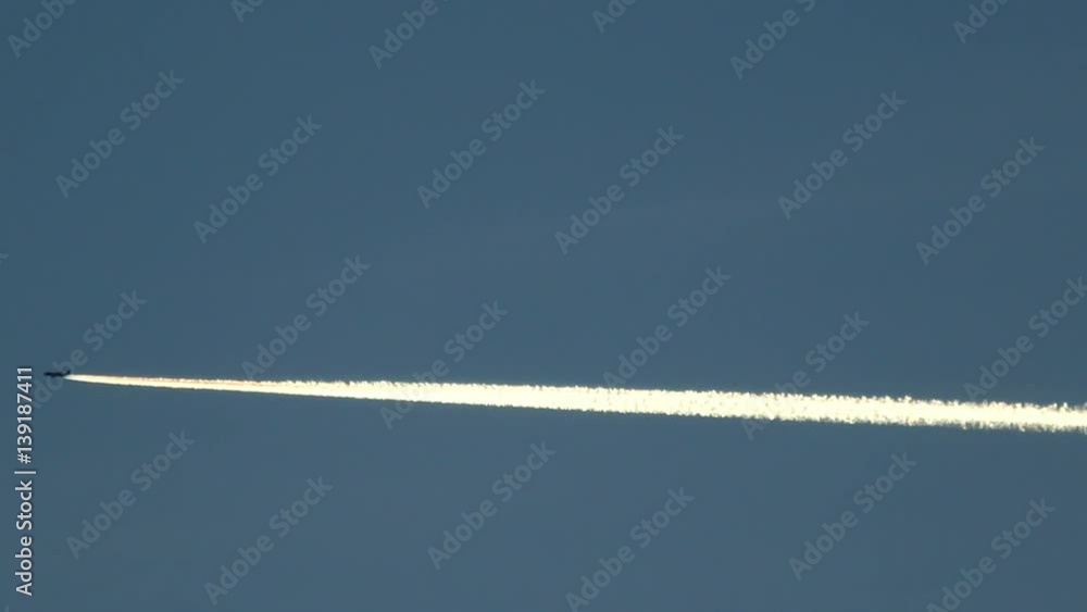 Jet Airplane Contrails Trails On Blue Sky Background Jet Airplane Contrails Trails On Blue Sky Background