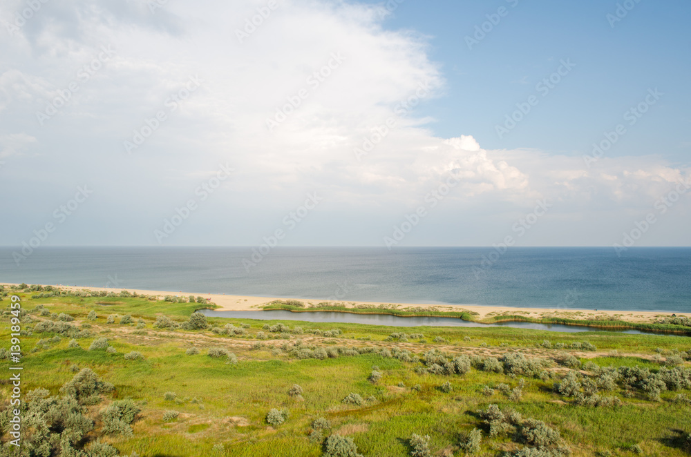 summer landscape, the sand on the beach, blue sea with waves. of bird flight view