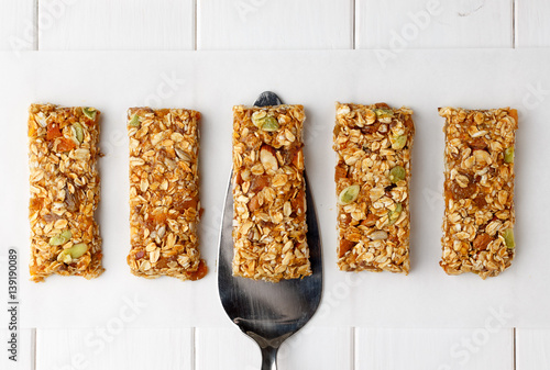 No bake energy granola bars on white wooden table.