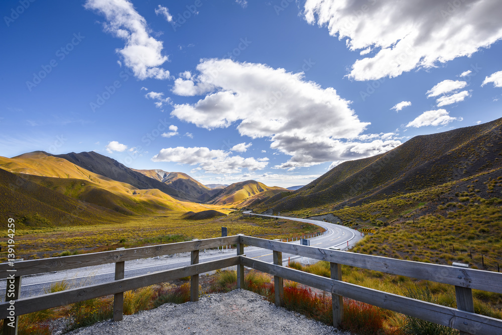 empty country road laying to the mountain in background scenery in the summer season with cleared sky empty country road laying to the mountain in background scenery in the summer season with cleared sky