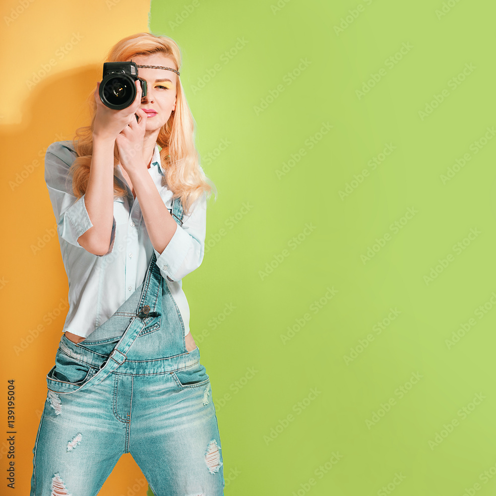 woman photographer making shots on a bright color background on a sunny day woman photographer making shots on a bright color background on a sunny day