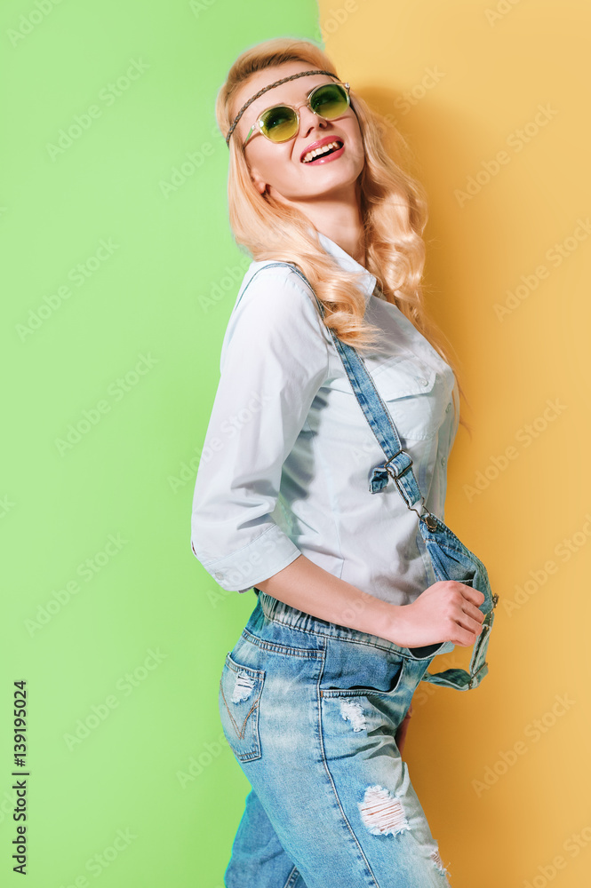 Spring girl in fashionable sunglasses on a bright color background Spring girl in fashionable sunglasses on a bright color background