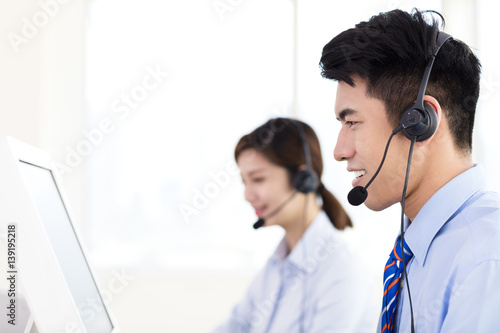 business Woman and man wearing headset in office