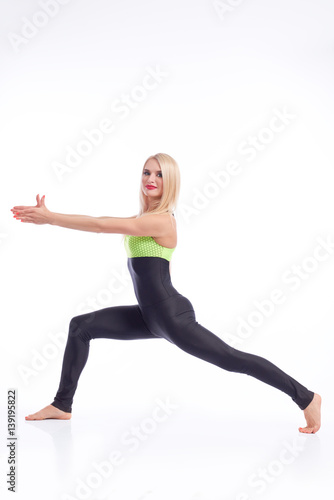 Attractive female gymnast exercising at studio 