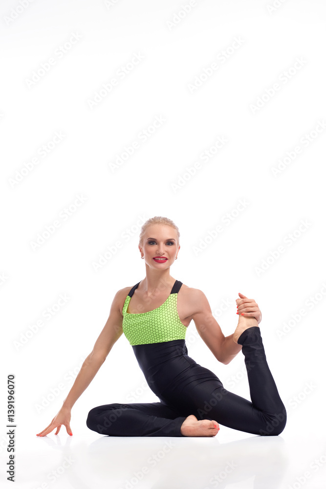 Gorgeous young woman practicing yoga sitting on the floor Gorgeous young woman practicing yoga sitting on the floor