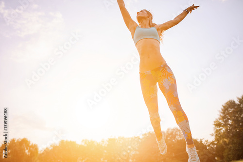 Young athletic girl playing with flying disc in the park. Professional player. Sport concept