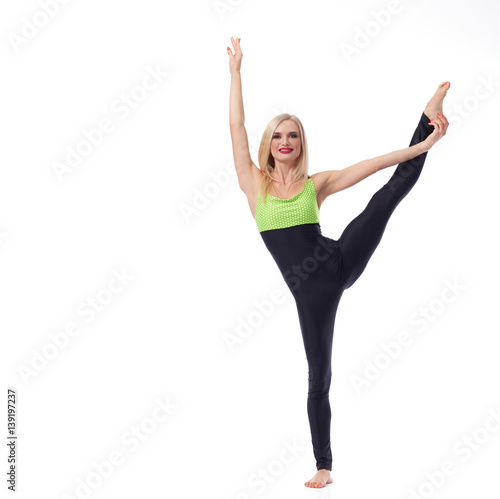 Attractive female gymnast exercising at studio  © serhiibobyk
