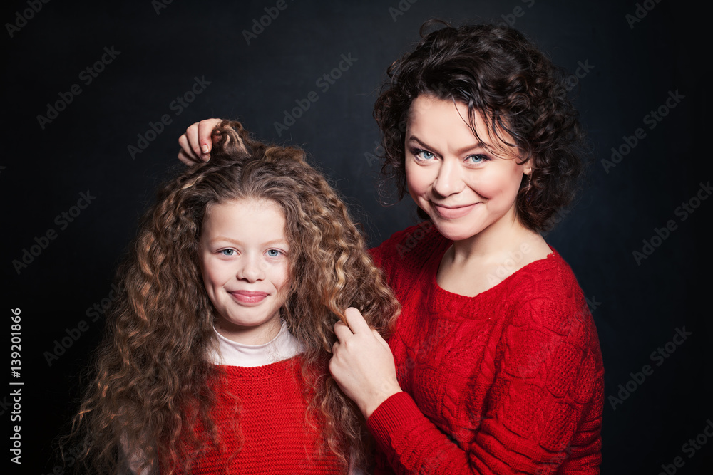 Smiling Mother and Daughter with Long Curly Hair. Happy Woman and Child Smiling Mother and Daughter with Long Curly Hair. Happy Woman and Child