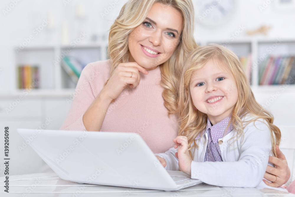 woman and girl using laptop woman and girl using laptop