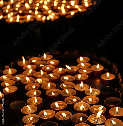 candles lit with the warm flame during the religious ceremony