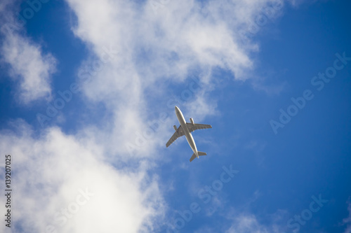 airplane in the blue sky with clouds