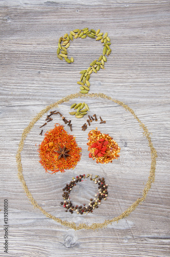 Spices arranged in a playful smileys on a wooden background