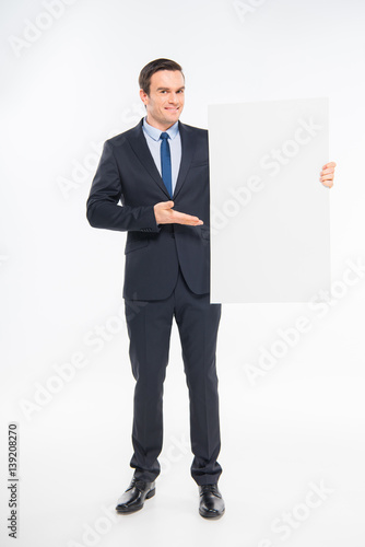 Businessman holding blank card