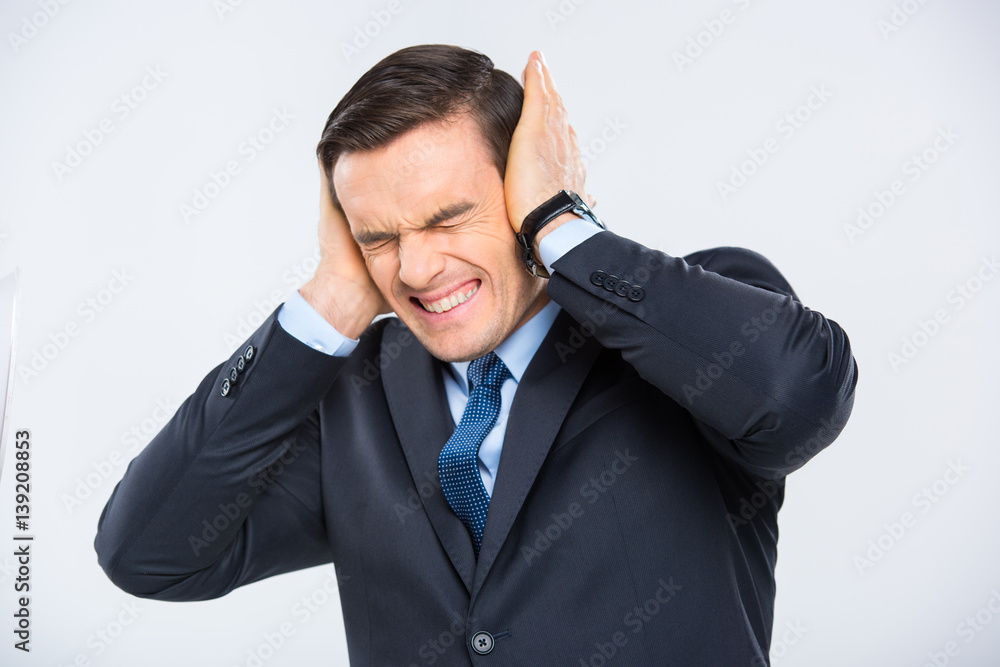 Businessman closing his ears Businessman closing his ears