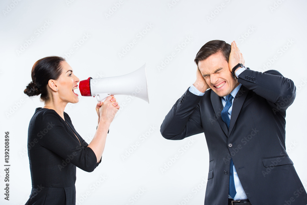 Businesswoman screaming at businessman