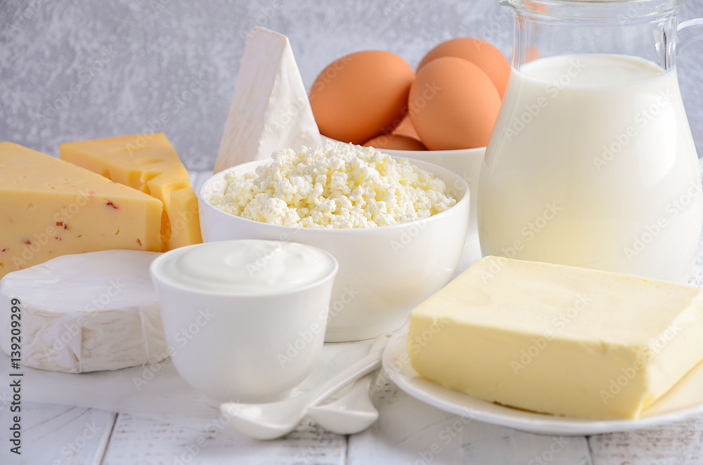 Fresh dairy products. Milk, cheese, brie, Camembert, butter, yogurt, cottage cheese and eggs on wooden table. Fresh dairy products. Milk, cheese, brie, Camembert, butter, yogurt, cottage cheese and eggs on wooden table.