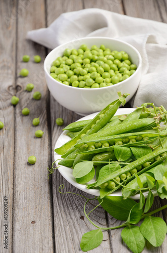 Fresh green peas on rustic wooden background, selective focus