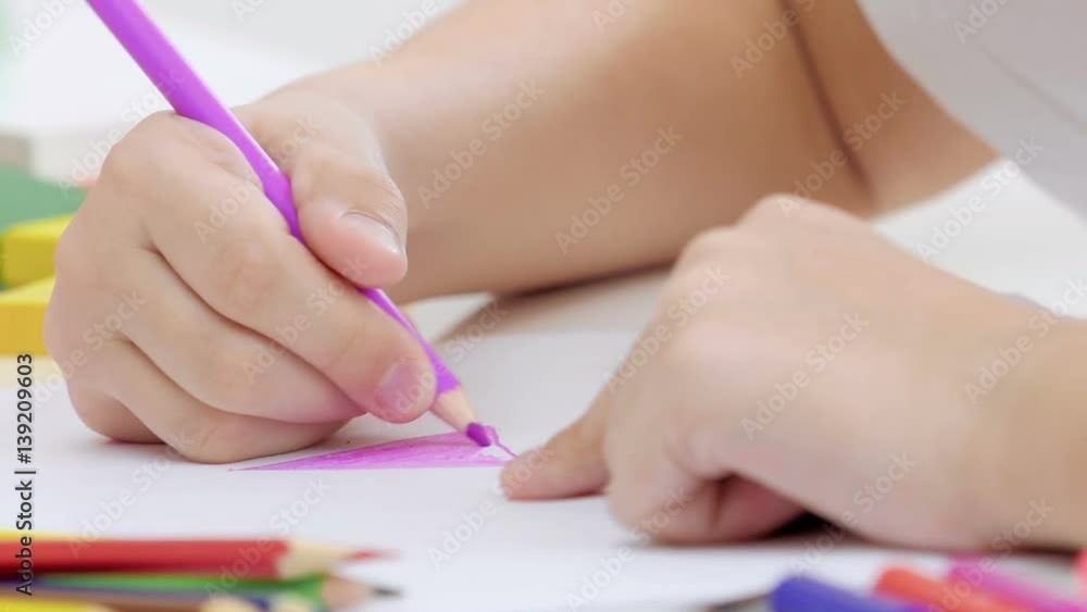 Little girl drawing a picture on the table. Close up. Little girl drawing a picture on the table. Close up.