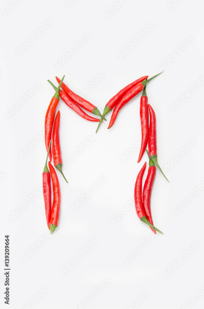 Bold letter M Latin alphabet of red hot chili pepper on a white background