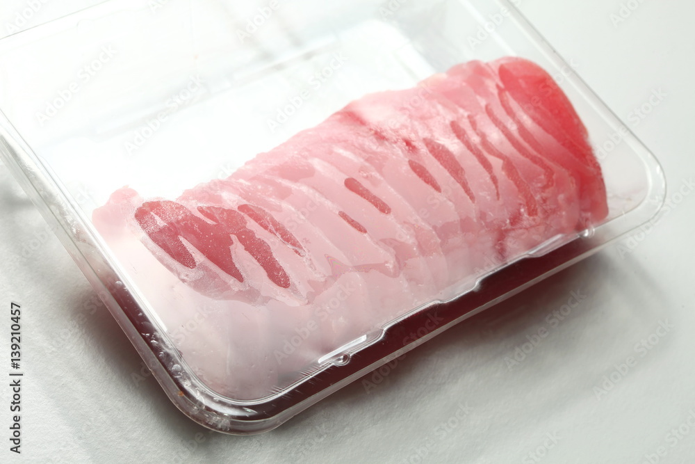 The fresh tuna slide in transparent plastic food containing represent the japanese food concept related idea. The fresh tuna slide in transparent plastic food containing represent the japanese food concept related idea.