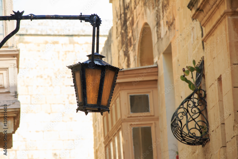 Picturesque facade with lanterns inside the ancient fortified city of Mdina, Malta. Maltese architecture