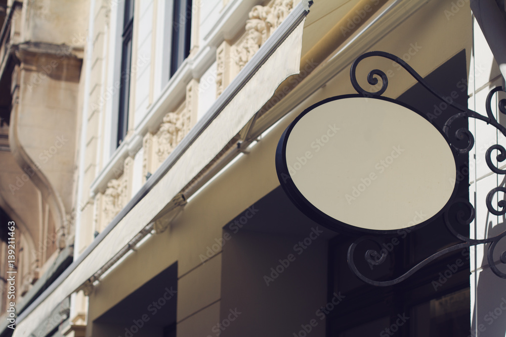 Fototapeta premium round empty signboard on a building with classical architecture