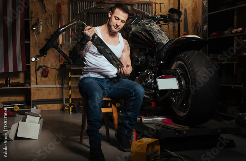 Smiling man working in the garage