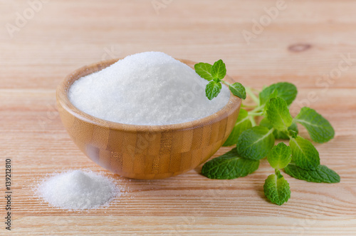 birch sugar xylitol in a wood bowl with mint on wooden