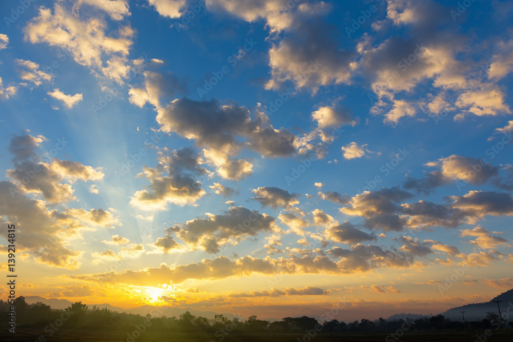 Dramatic sky include cloud, sunset or sunrise, outdoor space and horizon or skyline. Colorful with yellow, orange and blue color at evening in autumn. For scene, backdrop, background and wallpaper. Dramatic sky include cloud, sunset or sunrise, outdoor space and horizon or skyline. Colorful with yellow, orange and blue color at evening in autumn. For scene, backdrop, background and wallpaper.