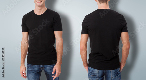 Shirt design and people concept - close up of young man in blank black t-shirt with shadow isolated.