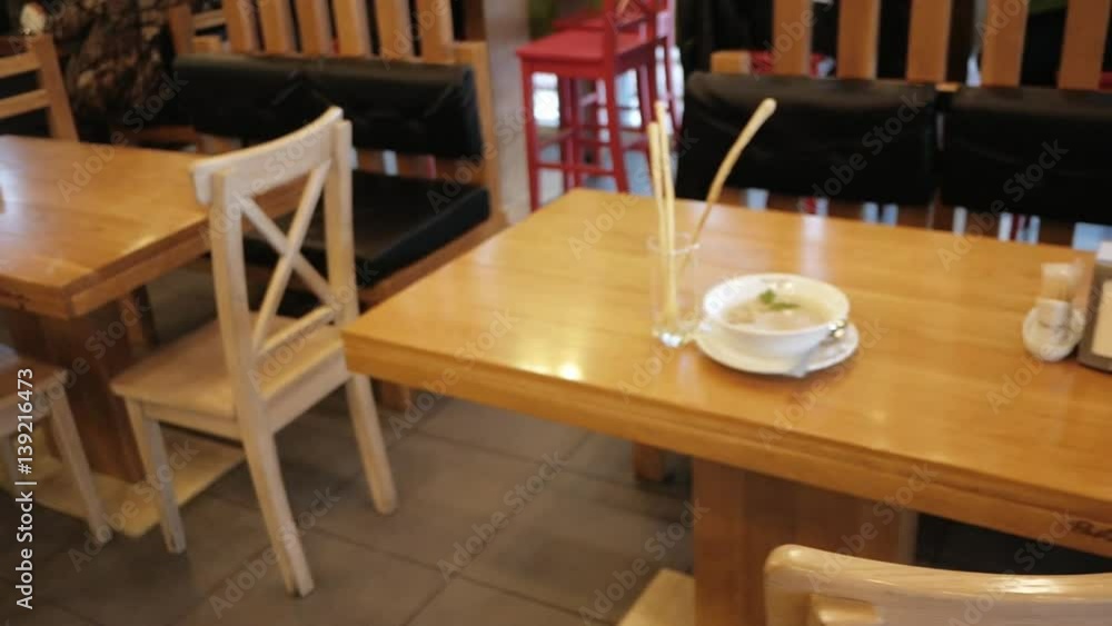Man photographs soup and breadsticks at a restaurant or cafe using his cellphone Man photographs soup and breadsticks at a restaurant or cafe using his cellphone