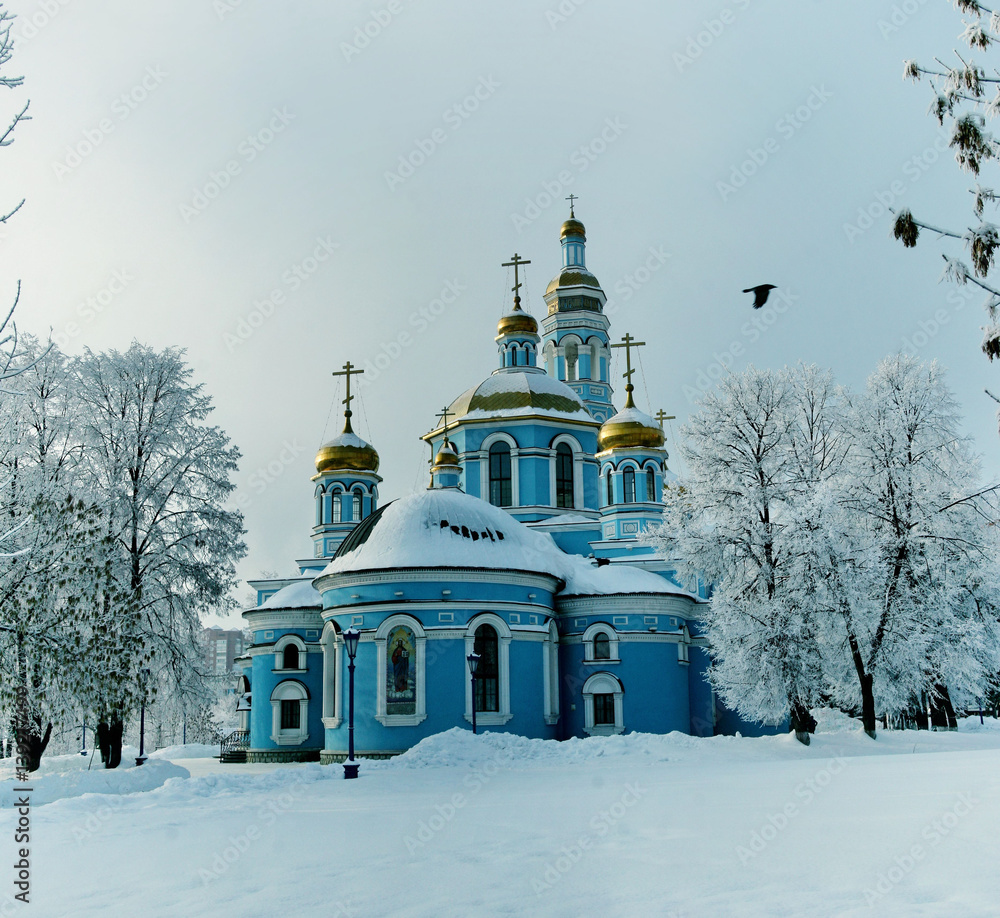 Snowy blue Orthodox Church with golden domes in winter Snowy blue Orthodox Church with golden domes in winter
