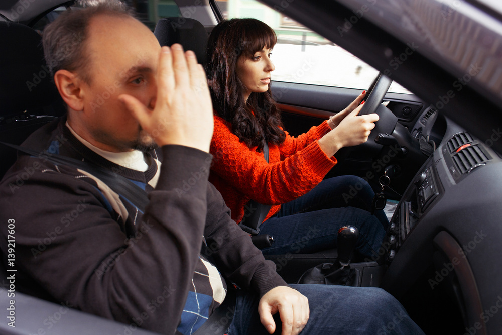 Exhausted driving instructor with female student