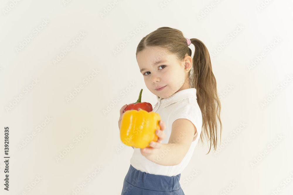Cute little girl offering a bunch of colorful bell peppers. Nutrition. Healthy food concept. Cute little girl offering a bunch of colorful bell peppers. Nutrition. Healthy food concept.