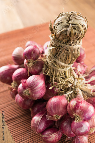 close up shallots on wood and bamboo background