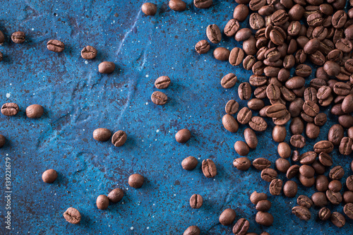 roasted coffee beans on blue table, can be used as a background