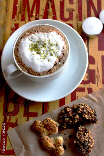 cappuccino with cookies and on the yellow red table photo