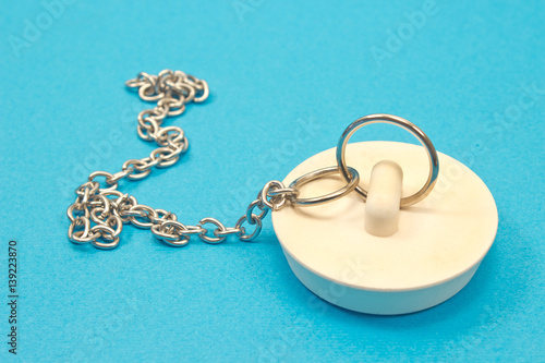 Sink plug with chain isolated on blue background