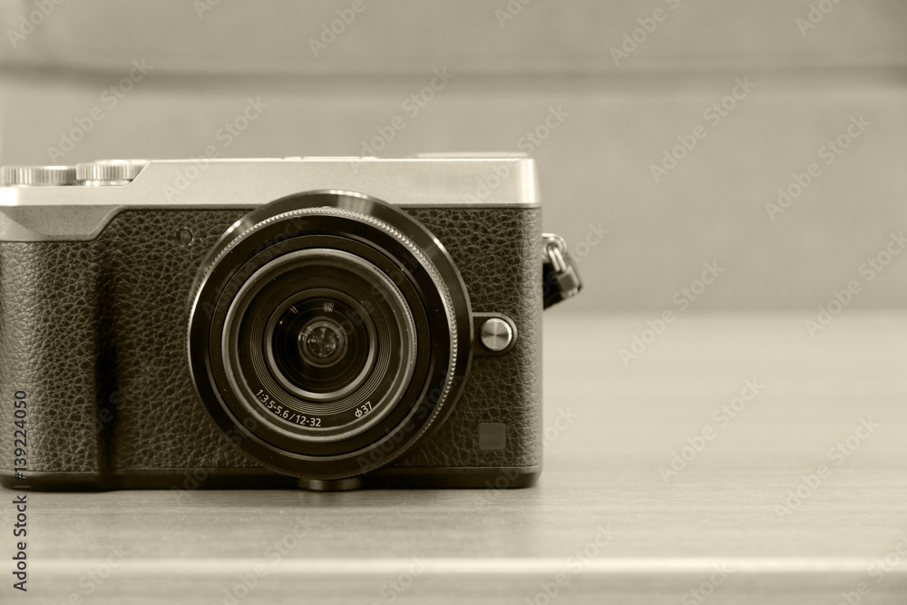 Mono-tone vintage camera on the table.
