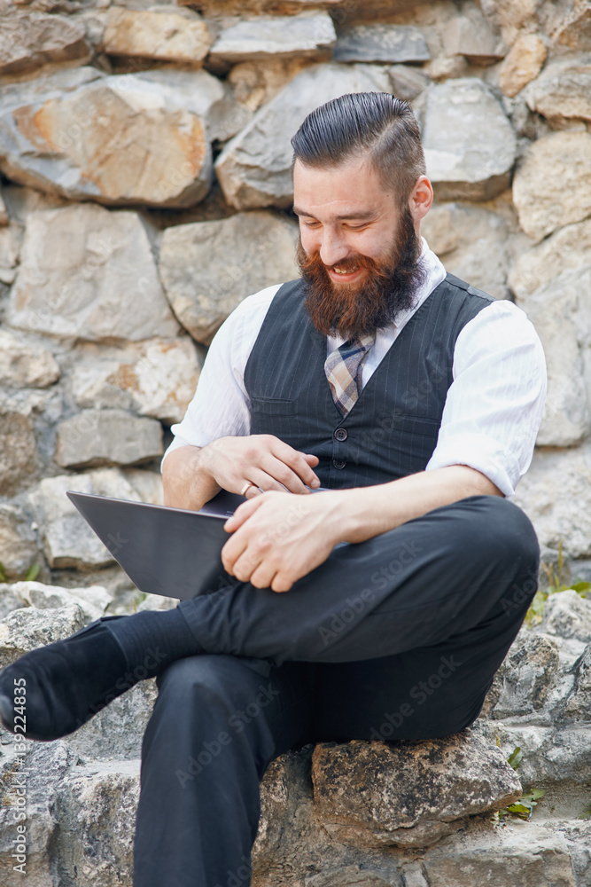 Portrait of a man with the laptop computer outdoors Portrait of a man with the laptop computer outdoors